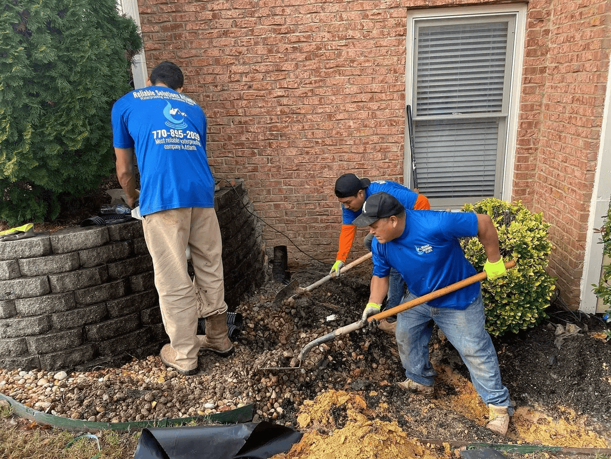 Drainage gravel installation at brick home