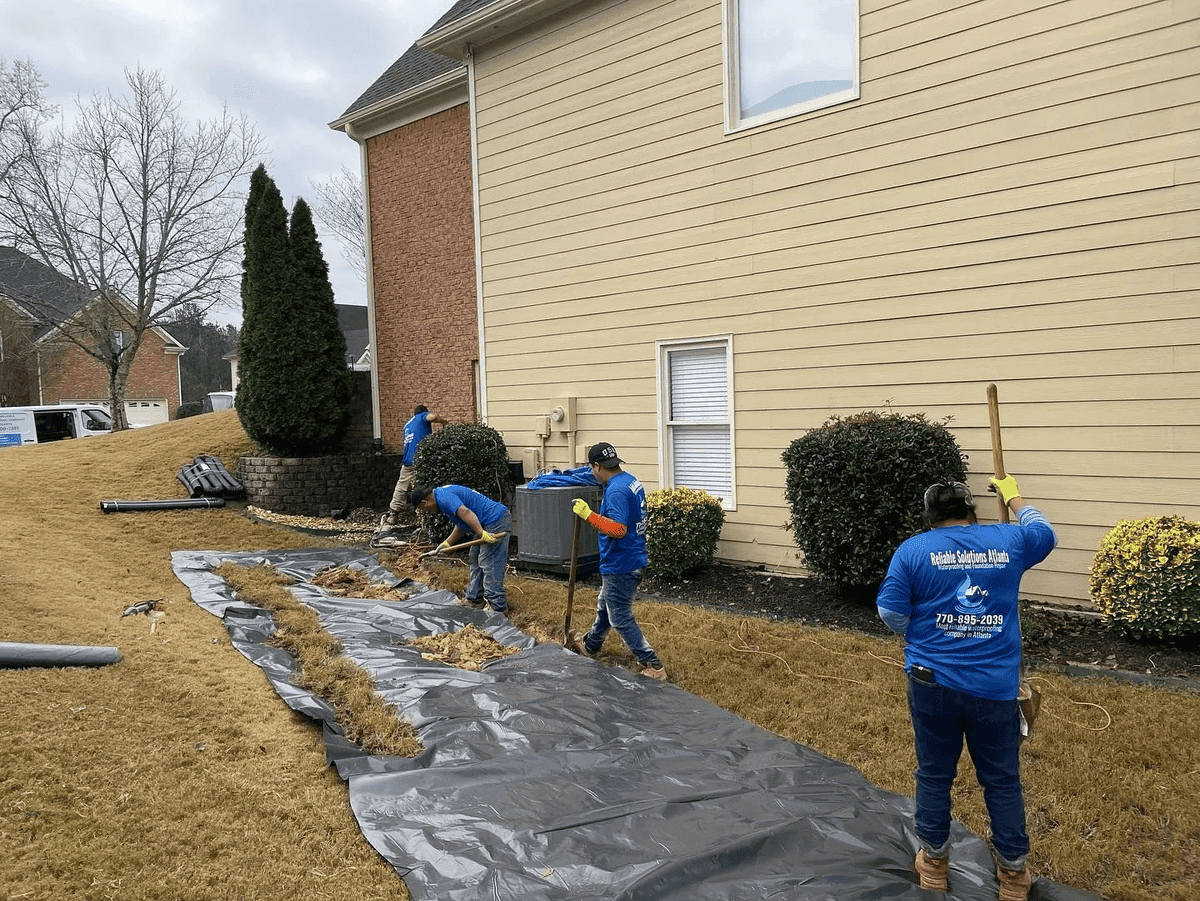 Crew digging French drain